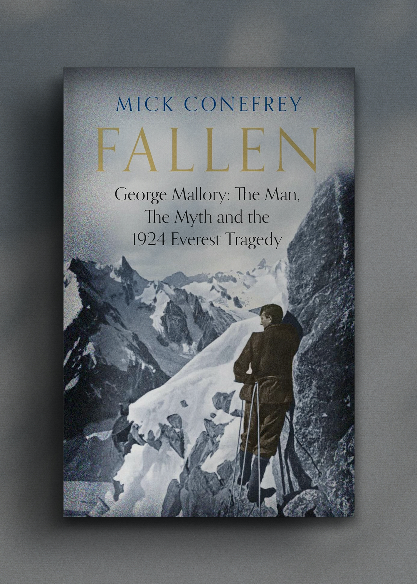 Cover of "Fallen" by Mick Conefrey. A climber stands on a snowy mountain ridge, gazing at distant peaks.